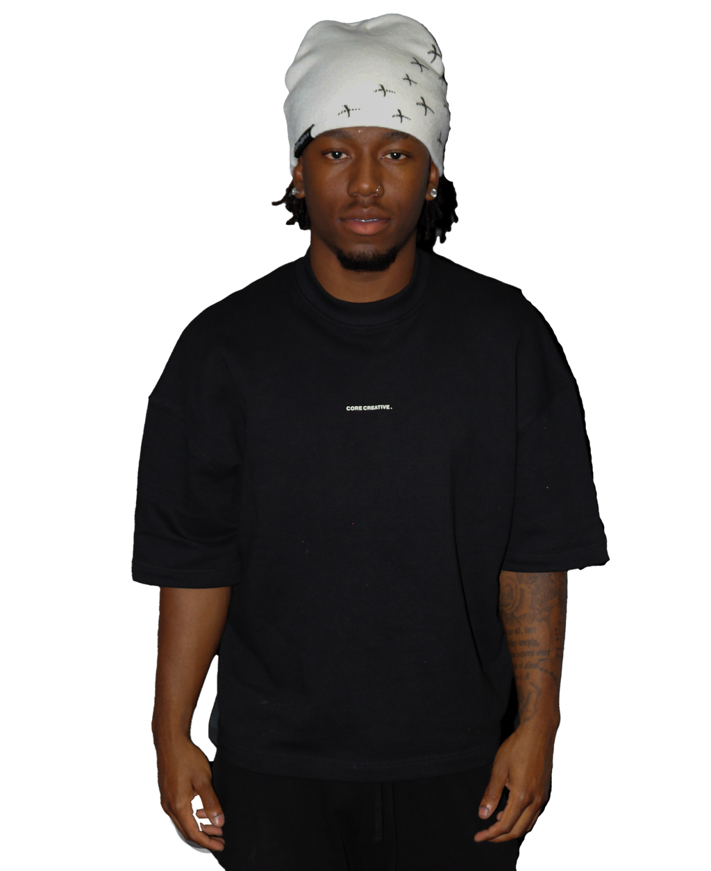 Model wearing a black oversized t-shirt and a stylish white beanie.